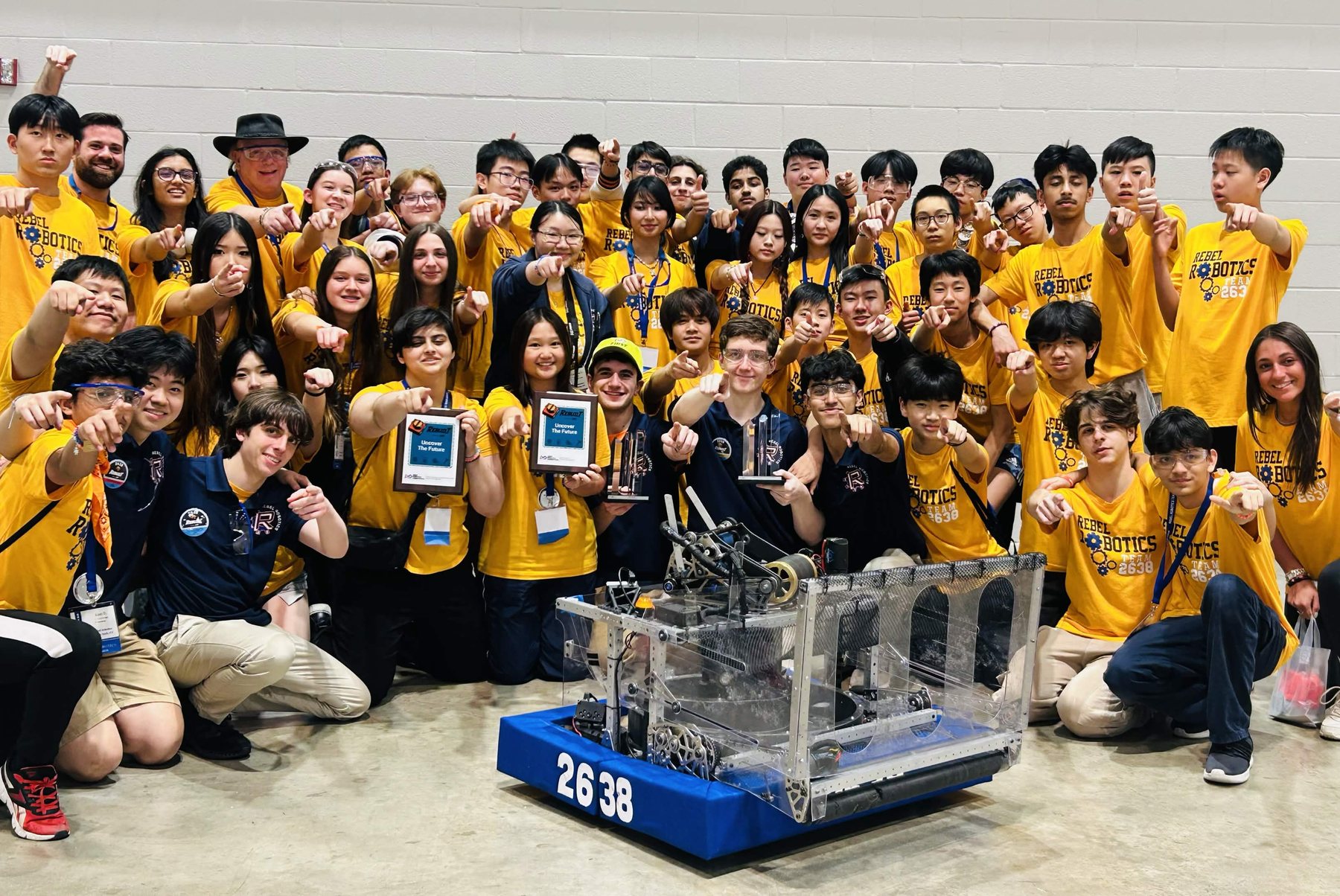 Rebel Robotics students with their robot and regional awards.
